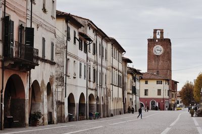 Street amidst old buildings in city against sky