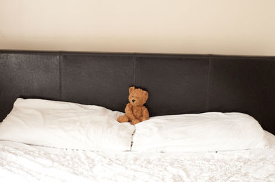 Close-up of teddy bear on bed at home