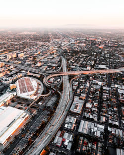 Aerial view of cityscape against sky during sunset
