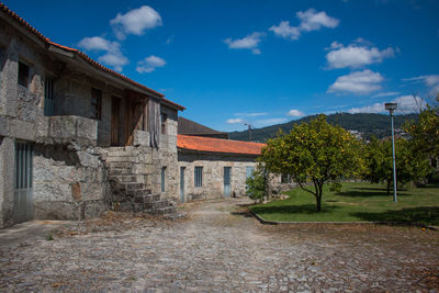 Houses on field against sky