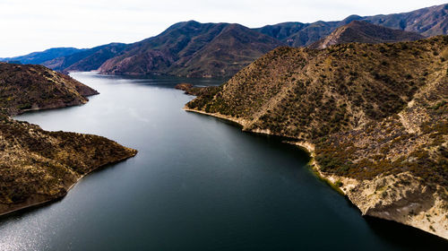 Scenic view of river amidst mountains against sky