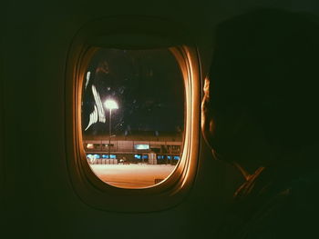 Reflection of man in illuminated car window