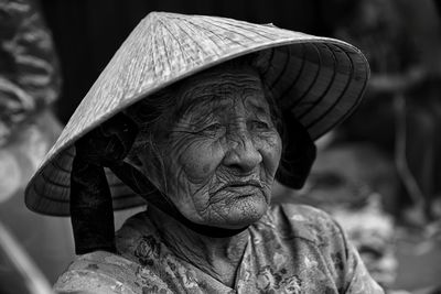 Senior woman wearing asian style conical hat