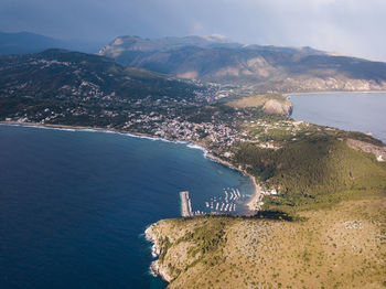 High angle view of sea and mountains against sky