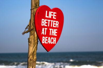 Close-up of signboard against clear sky