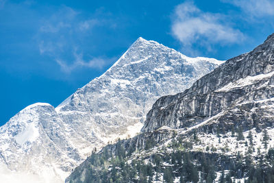 Scenic view of snow covered mountains against sky