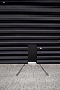 Black door in black metal building facade, denmark