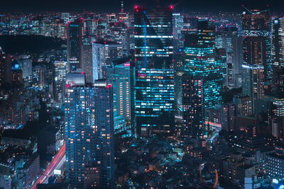 High angle view of illuminated city buildings at night