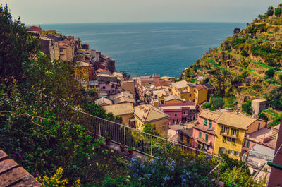 High angle view of town by sea against sky