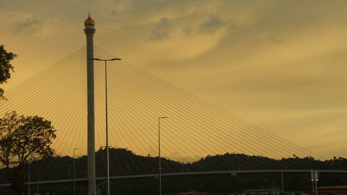 Low angle view of silhouette bridge against sky during sunset