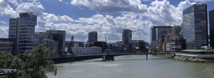 Panoramic view of river and buildings against sky