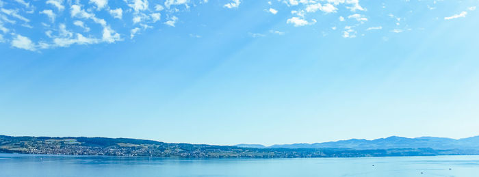 Scenic view of sea against blue sky