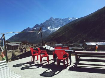 View of chairs on mountain against clear sky