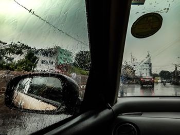 Reflection of cars on wet window during rainy season