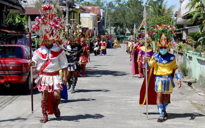 Rear view of people walking on street