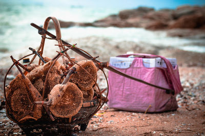 Close-up of wicker basket on shore