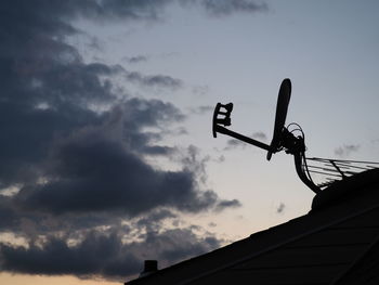 Low angle view of telephone pole against sky