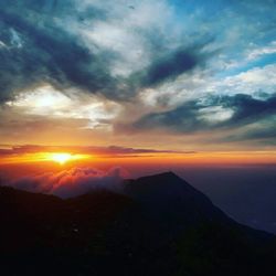 Scenic view of silhouette mountains against sky during sunset