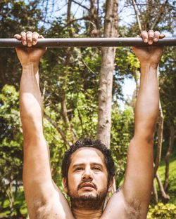 Low angle view of man hanging from tree