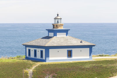 Building by sea against sky