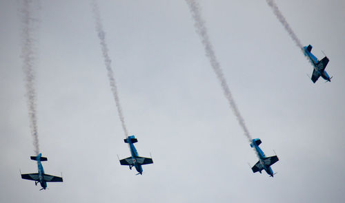 Low angle view of airshow against sky