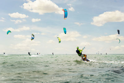 People in sea against sky