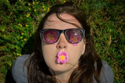 Woman with flower on mouth