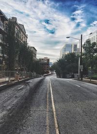 Surface level of road by buildings against sky
