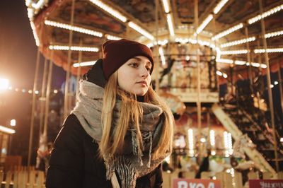 Woman looking at amusement park during winter