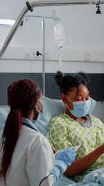 Rear view of doctor examining patient at clinic