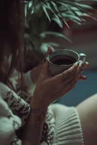 Midsection of woman drinking glass