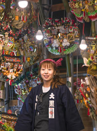 Portrait of smiling young woman standing in market