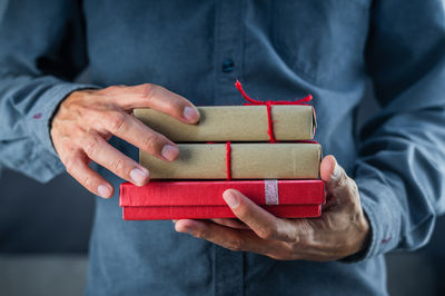 Close-up of man holding red stack