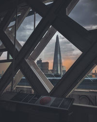 Low angle view of bridge and buildings against sky