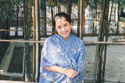 Portrait of smiling young woman standing outdoors