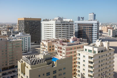 Buildings in city against clear sky