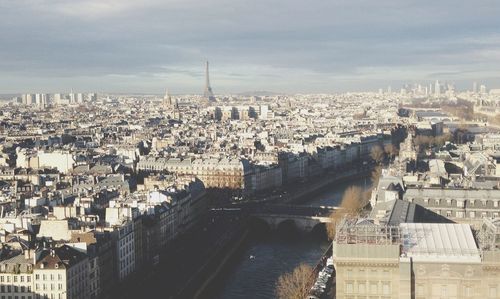 Cityscape against cloudy sky