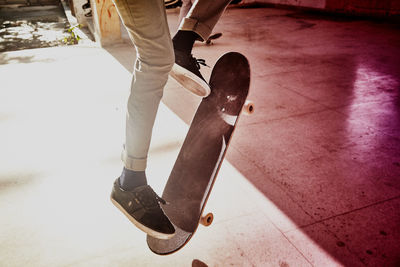 Low section of man standing on skateboard