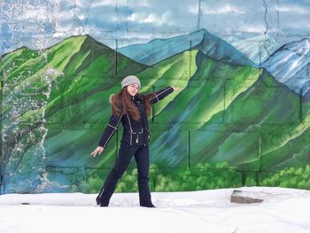 Woman photographing with umbrella standing in winter