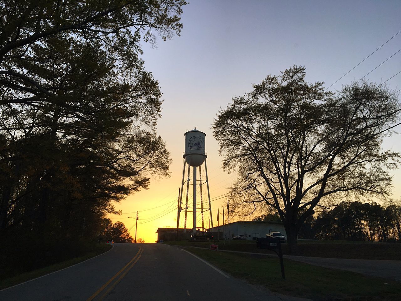 SILHOUETTE OF WATER TOWER AGAINST SKY