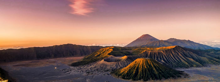 Scenic view of volcanic landscape against sky during sunset