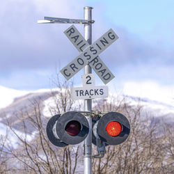 Low angle view of road sign against sky