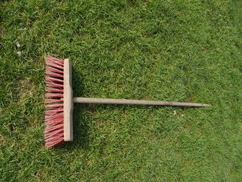 Directly above shot of broom on grassy field in yard