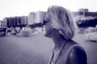 Woman at beach during dusk in city