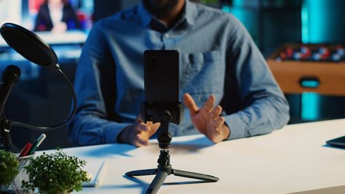 Midsection of businessman working on table