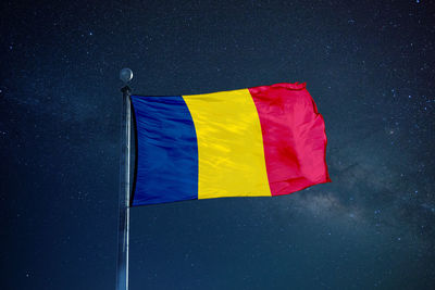Low angle view of flag against sky at night