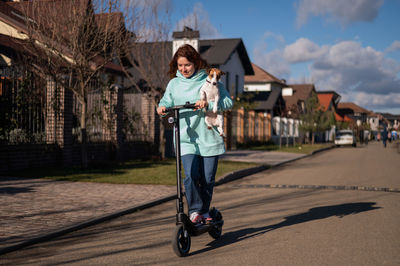 Rear view of woman walking on road