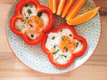 High angle view of egg and capsicum in plate on table