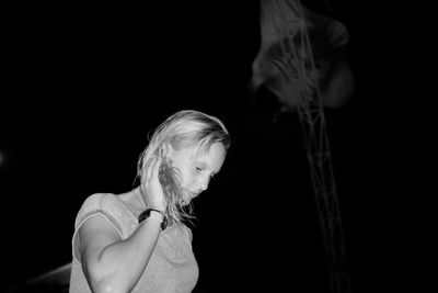 Low angle view of woman against manta ray at aquarium