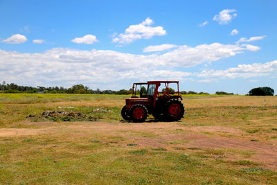 Tractor on field against sky